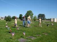 Troop 804 scouts place flags on graves of Veterans