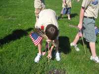 Troop 804 scouts place flags on graves of Veterans